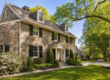 Stone Colonial home in Chester County PA with seamless gutters and gutter guards installed along the roofline