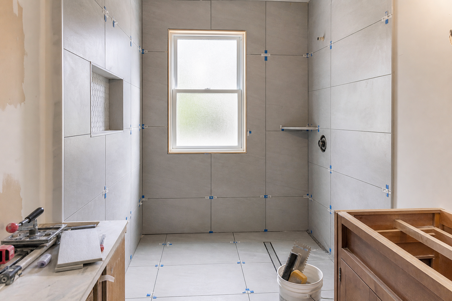 Large-format porcelain tile installation in a small bathroom renovation in Chester County Pennsylvania