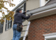Contractor installing seamless aluminum gutters showing gutter installation cost Chester County PA factors