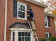 contractor performing window replacement on a brick home in Chester County PA